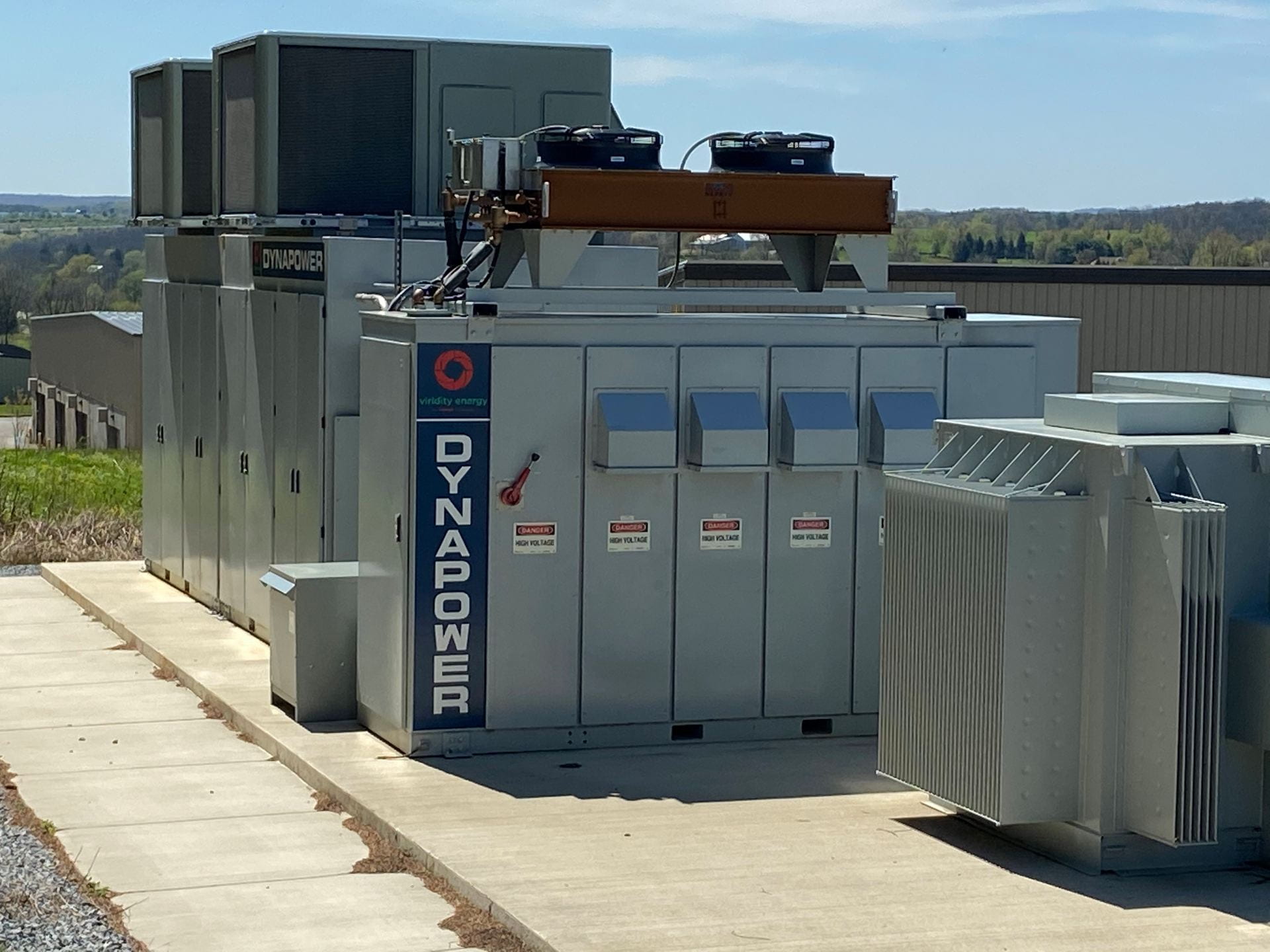 Battery storage (Dynapower) at a GSSD site. Note cooling fans on top of battery unit. Transformer in front. Credit: Penn State MCOR